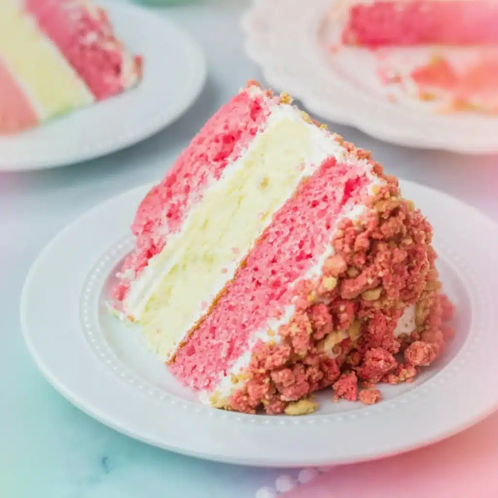 strawberry cheesecake cake with cream layers and crunchy topping