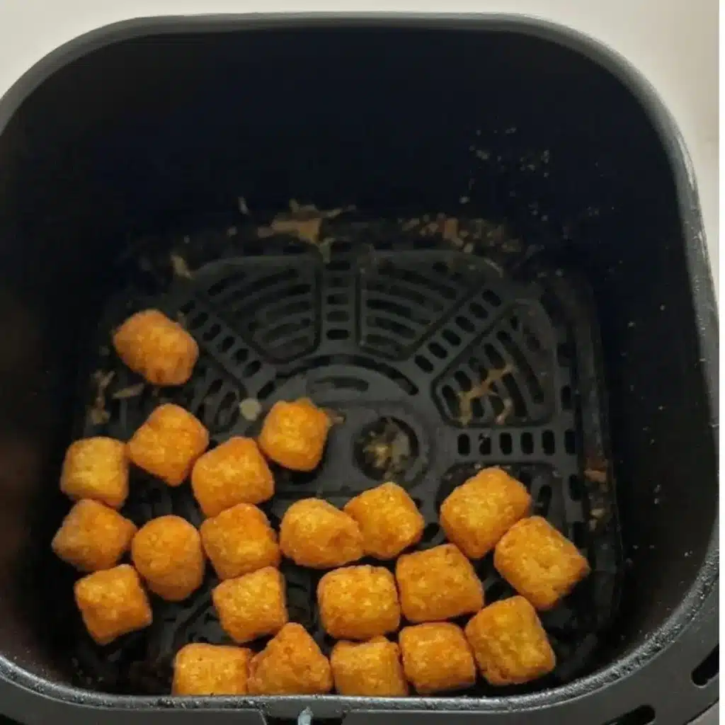 Alexia sweet potato puffs cooking in air fryer basket