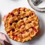 Baked strawberry rhubarb pie with golden lattice crust