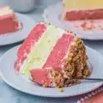 moist strawberry cake with cheesecake center served on a white plate