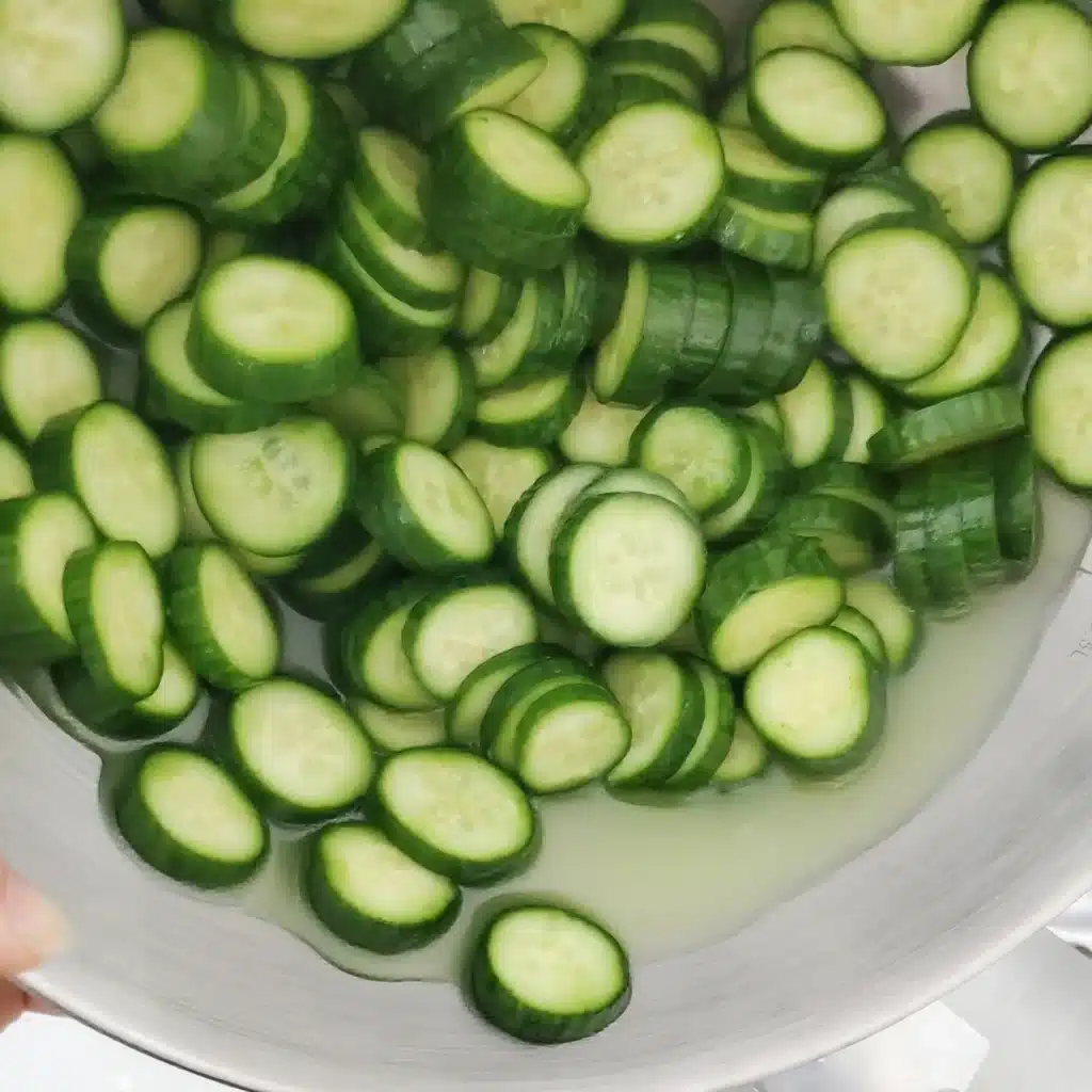 Salted cucumbers in a bowl with water released from salting