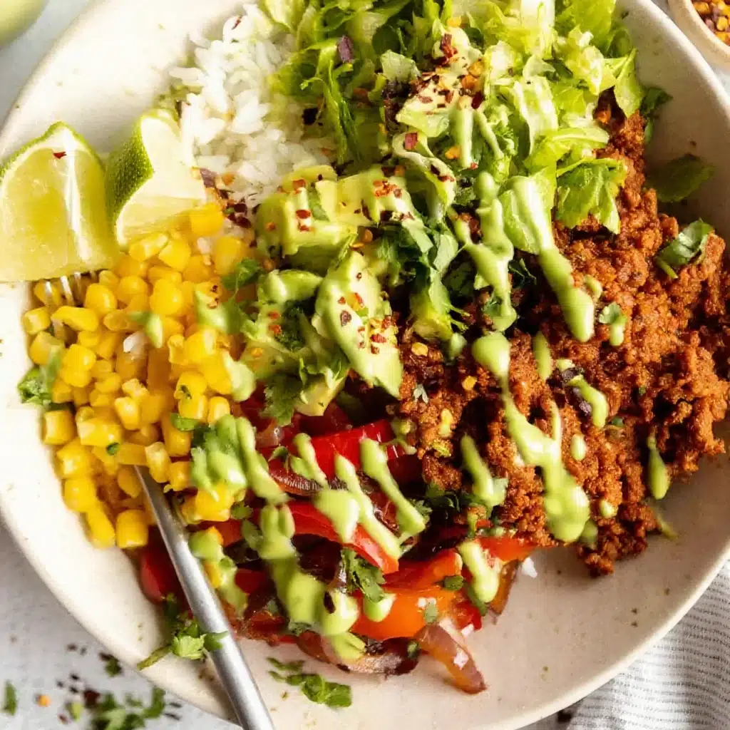 Ground beef burrito bowl with avocado and green drizzle