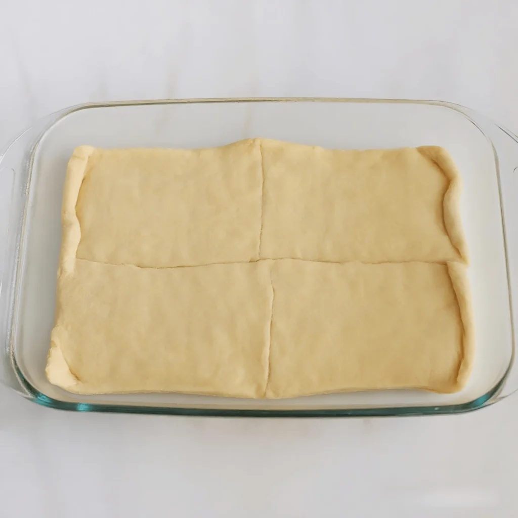 Churro Cheesecake Recipe 5 Crescent roll dough pressed into baking dish