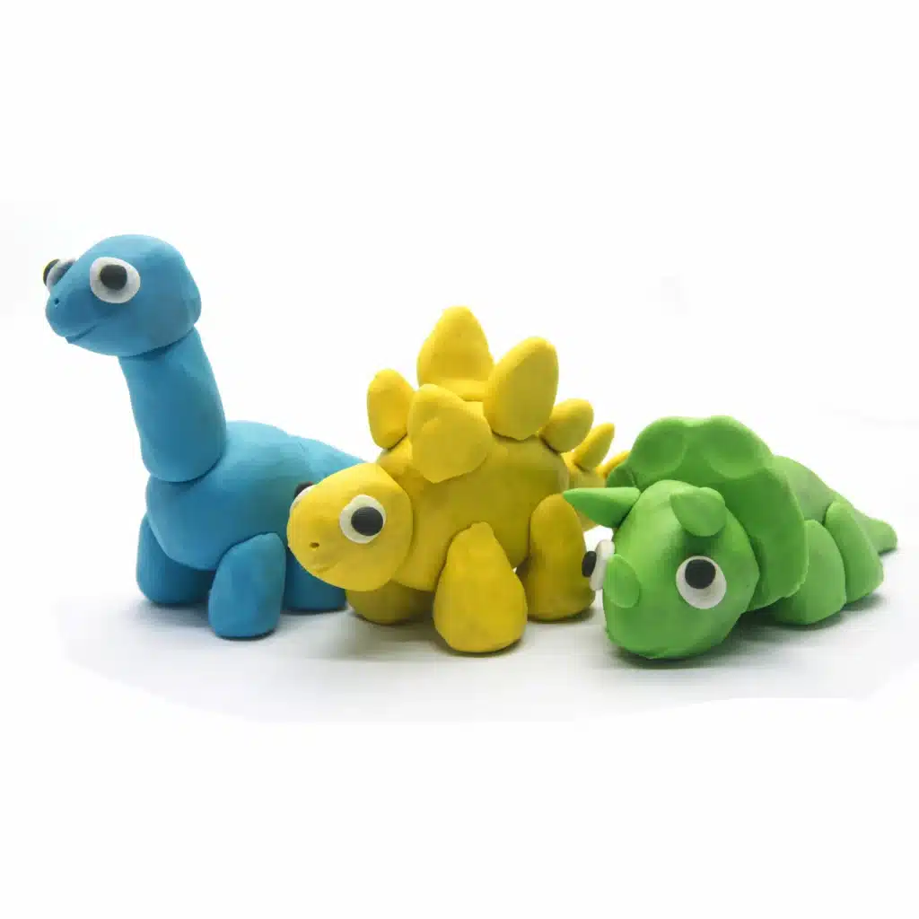 Cloud Dough Recipe 3 Colorful dinosaur figures made from cloud dough.
