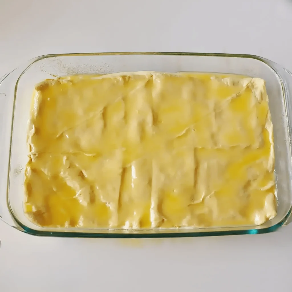 Churro Cheesecake Recipe 7 Crescent dough brushed with egg wash in baking dish